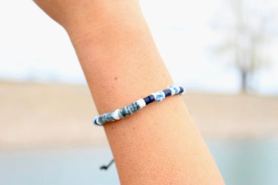 Coco shell bracelet with dyed bead accents laid flat