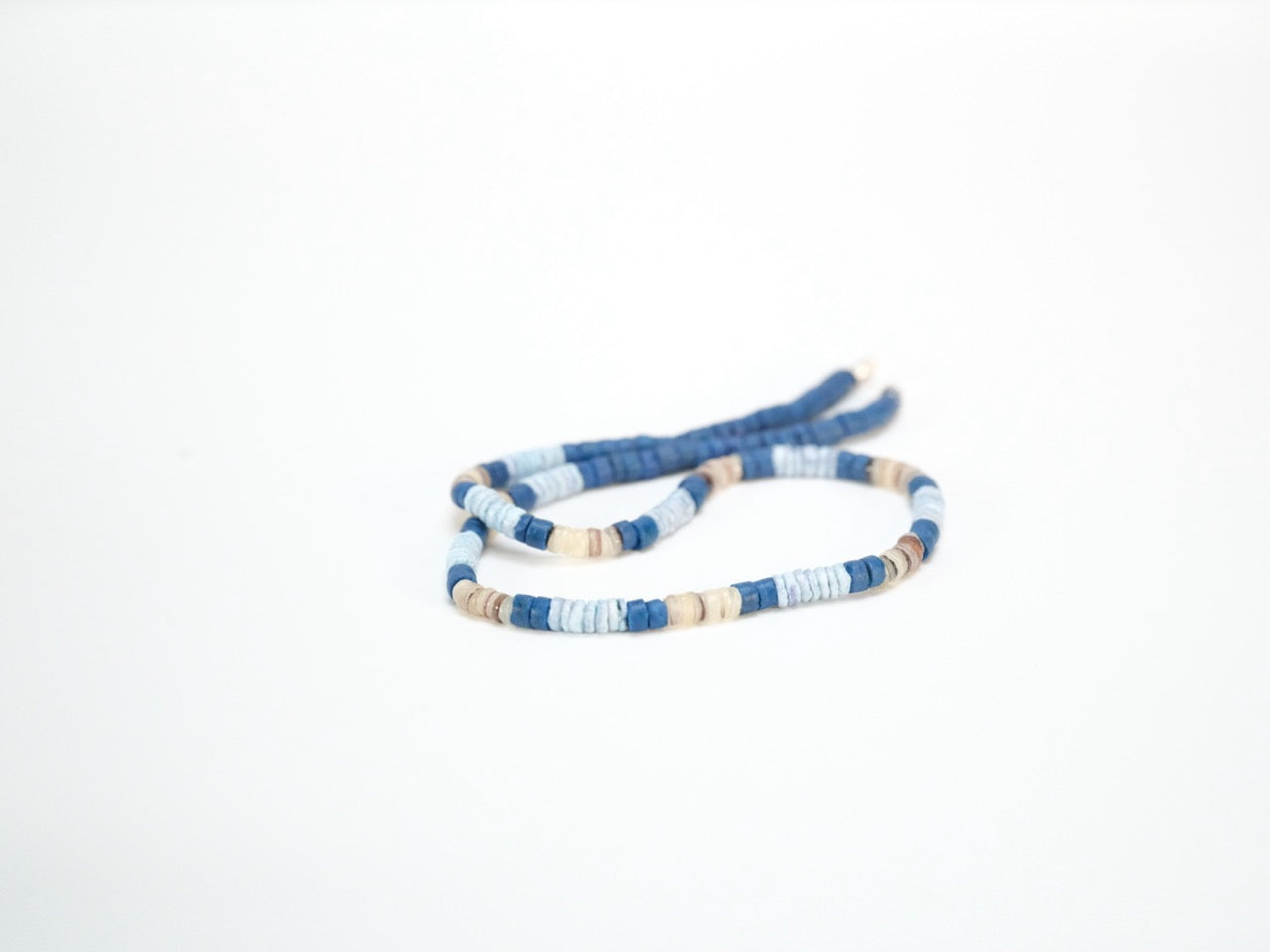 Coco shell necklace with dyed natural beads laid flat