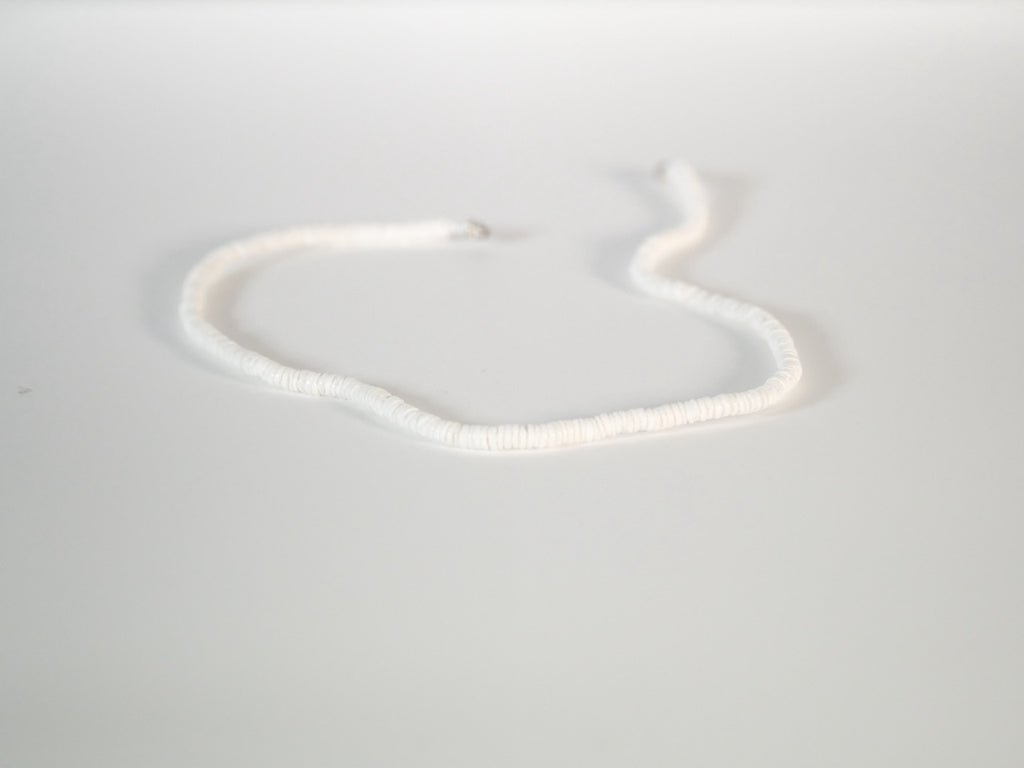 White puka shell necklace with natural clam shells detail view