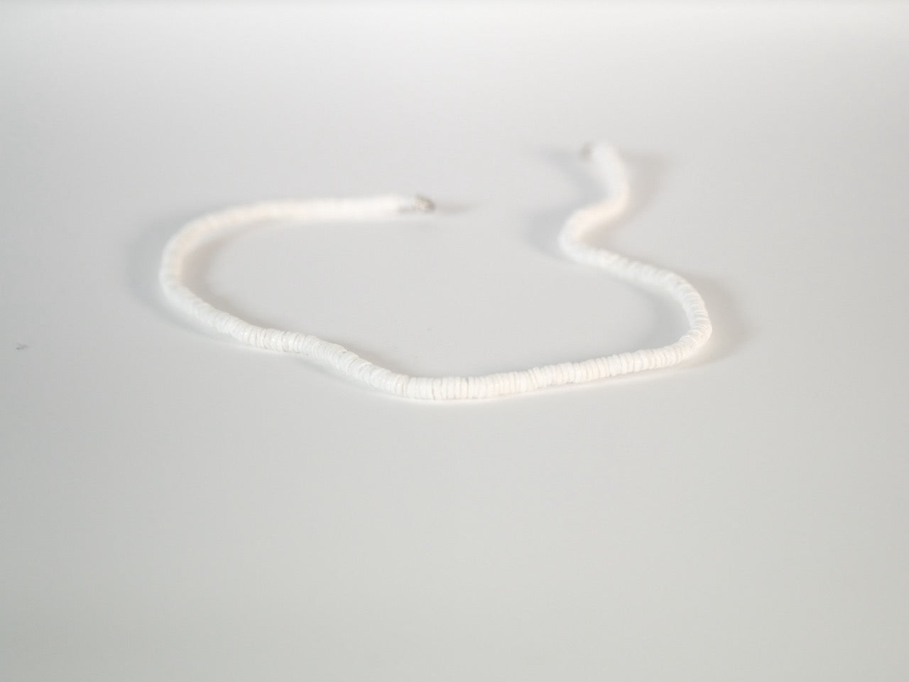 White puka shell necklace with natural clam shells detail view