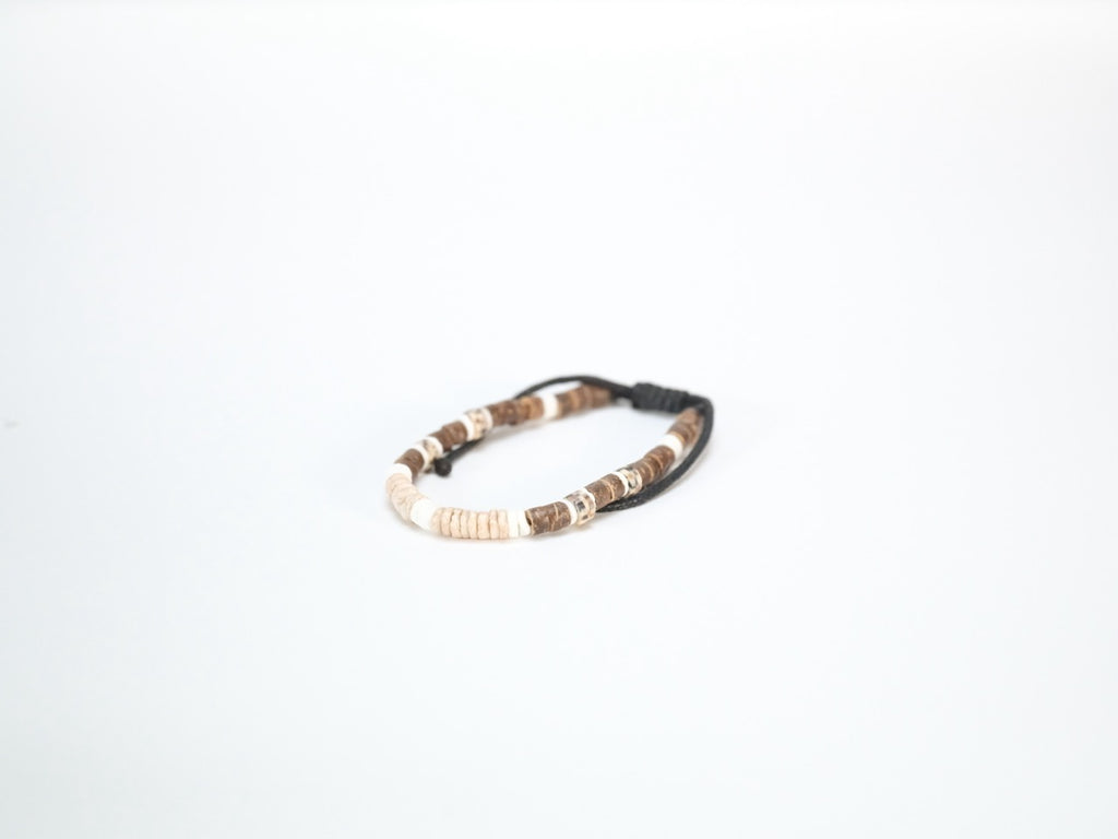 Coco shell bracelet with dyed bead accents laid flat