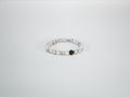Black lava bead bracelet with white stone accents side view