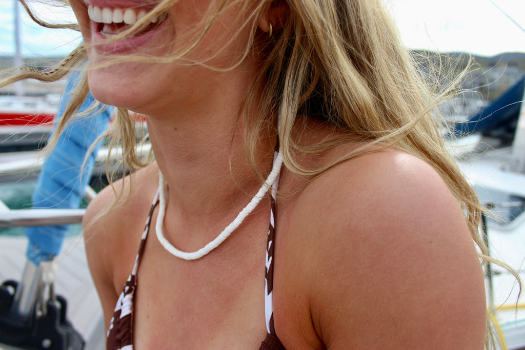 White puka shell necklace with natural clam shells laid flat